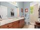 Well-lit bathroom with a dual sink vanity, neutral colors, and a walk-in shower at 2030 Waterford Estates Dr, New Smyrna Beach, FL 32168