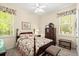 Charming bedroom featuring a decorative floral bedspread and window views at 2030 Waterford Estates Dr, New Smyrna Beach, FL 32168