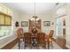 Formal dining room featuring classic decor, hardwood floors, and a large window with natural light at 2030 Waterford Estates Dr, New Smyrna Beach, FL 32168