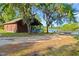 Charming house exterior with lake and dock access, surrounded by lush greenery at 2030 Waterford Estates Dr, New Smyrna Beach, FL 32168