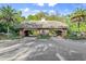 An entrance gate for a neighborhood, with tropical landscaping, plants and palm trees at 2030 Waterford Estates Dr, New Smyrna Beach, FL 32168