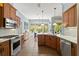 Spacious kitchen with wood cabinets, stainless appliances, and tile floors at 2030 Waterford Estates Dr, New Smyrna Beach, FL 32168