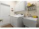 Functional laundry room equipped with modern appliances and ample storage space at 2030 Waterford Estates Dr, New Smyrna Beach, FL 32168