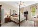Comfortable main bedroom with four-poster bed and carpet at 2030 Waterford Estates Dr, New Smyrna Beach, FL 32168
