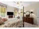 Bright main bedroom with windows and dark wood furniture at 2030 Waterford Estates Dr, New Smyrna Beach, FL 32168