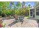 Outdoor patio area perfect for entertaining, featuring a dining set and garden views at 2030 Waterford Estates Dr, New Smyrna Beach, FL 32168