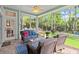 Relaxing screened porch featuring comfortable seating and a serene backyard view at 2030 Waterford Estates Dr, New Smyrna Beach, FL 32168