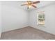 Bright bedroom with neutral carpet, ceiling fan, and natural light at 211 S Delaware Ave, Deland, FL 32720