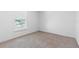 Cozy bedroom with neutral carpet and natural light from the window at 211 S Delaware Ave, Deland, FL 32720