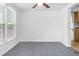 Bright dining area featuring tile flooring, and a ceiling fan, adjacent to the kitchen at 211 S Delaware Ave, Deland, FL 32720