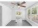 Bright dining room with modern lighting, gray tile flooring, and large windows at 211 S Delaware Ave, Deland, FL 32720