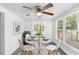 Bright dining room with modern lighting, glass table, and white chairs at 211 S Delaware Ave, Deland, FL 32720