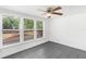 Bright and airy room with large windows, gray tile flooring, and ample natural light at 211 S Delaware Ave, Deland, FL 32720