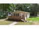 Cozy single-story home featuring a inviting front porch, nestled in a serene, tree-filled neighborhood at 211 S Delaware Ave, Deland, FL 32720