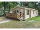 Charming single-story home with a wooden porch and landscaped front yard at 211 S Delaware Ave, Deland, FL 32720