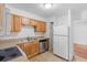 Efficient kitchen with wood cabinetry and functional layout with standard appliances at 211 S Delaware Ave, Deland, FL 32720