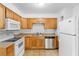 Cozy kitchen featuring wood cabinetry, neutral countertops, and essential appliances at 211 S Delaware Ave, Deland, FL 32720