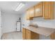 Functional laundry area with ample cabinet space and tile flooring at 211 S Delaware Ave, Deland, FL 32720