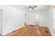 Light-filled living room with hardwood floors, ceiling fan, and an open design at 211 S Delaware Ave, Deland, FL 32720