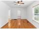 Inviting living room with hardwood flooring and a ceiling fan, perfect for gatherings at 211 S Delaware Ave, Deland, FL 32720
