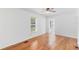 Bright living room with warm-toned wood floors and a ceiling fan at 211 S Delaware Ave, Deland, FL 32720