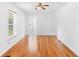 Inviting living room featuring gleaming hardwood floors and natural light at 211 S Delaware Ave, Deland, FL 32720
