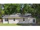 Image of the rear exterior of a one-story house showing light siding and a back door at 211 S Delaware Ave, Deland, FL 32720