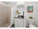 Bathroom featuring a sleek vanity, well-lit mirror, a shower with nice tile, and contemporary decor at 2145 8Th Ave, Deland, FL 32724
