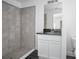 Bathroom featuring a tiled stand up shower and vanity with dark countertop at 2145 8Th Ave, Deland, FL 32724