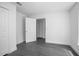 Bright bedroom with grey wood-look flooring and an open closet door at 2145 8Th Ave, Deland, FL 32724