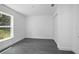 A minimalist bedroom with natural light, closet, and gray wood-look flooring at 2145 8Th Ave, Deland, FL 32724
