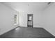 Clean bedroom with gray wood-look floors, a large window, and a view into the bathroom at 2145 8Th Ave, Deland, FL 32724