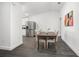 Cozy dining area with a dark wood table, comfortable chairs, and an adjacent stainless steel refrigerator at 2145 8Th Ave, Deland, FL 32724