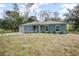 View of the home with an attached garage, and lawn with utilities in the front yard at 2145 8Th Ave, Deland, FL 32724
