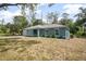 View of the side of the home with attached garage, and new lawn at 2145 8Th Ave, Deland, FL 32724