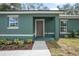Inviting home entrance showing a walkway to a covered front door framed by white-trimmed windows at 2145 8Th Ave, Deland, FL 32724