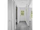 Hallway with grey flooring leading to an exterior door at 2145 8Th Ave, Deland, FL 32724