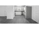 Well-lit kitchen showcasing stainless steel appliances, white cabinetry, and gray wood-look flooring at 2145 8Th Ave, Deland, FL 32724