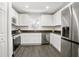 Modern kitchen with white cabinets, stainless steel appliances, and dark countertops for a sleek look at 2145 8Th Ave, Deland, FL 32724