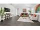 Bright living room with modern decor, dark floors, stylish furniture, and a decorative rug at 2145 8Th Ave, Deland, FL 32724