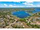 Expansive aerial view showcases the home's proximity to the lake and surrounding neighborhood at 2150 Deck Ct, Deltona, FL 32738