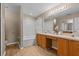 Bright bathroom with dual vanities, tiled tub/shower combo, and wood-look floors at 2150 Deck Ct, Deltona, FL 32738