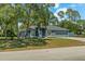 Charming single-story home featuring a well-maintained lawn, blue paint, and a two-car garage at 2150 Deck Ct, Deltona, FL 32738