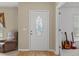 Light-filled foyer with wood flooring, decorative front door, and neutral wall colors at 2150 Deck Ct, Deltona, FL 32738