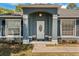 Inviting front entrance with decorative columns, arched entryway, and lush landscaping at 2150 Deck Ct, Deltona, FL 32738