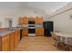 Well-lit kitchen with wooden cabinets, black appliances, and a cozy breakfast area at 2150 Deck Ct, Deltona, FL 32738