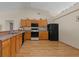 Functional kitchen with wooden cabinets, neutral countertops, and a suite of essential appliances at 2150 Deck Ct, Deltona, FL 32738