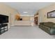 Open-concept living room with a high ceiling and views into the kitchen, featuring neutral tones at 2150 Deck Ct, Deltona, FL 32738