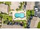 Aerial view of a community with a uniquely shaped pool, palm trees, and green space at 2200 S Palmetto Ave # B060, Daytona Beach, FL 32119