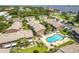 Aerial view of the community pool and lush landscaping near a waterfront area at 2200 S Palmetto Ave # B060, Daytona Beach, FL 32119